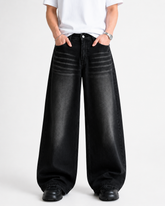 Men's black baggy jeans featuring premium denim fabric, functional pockets and fade detailing