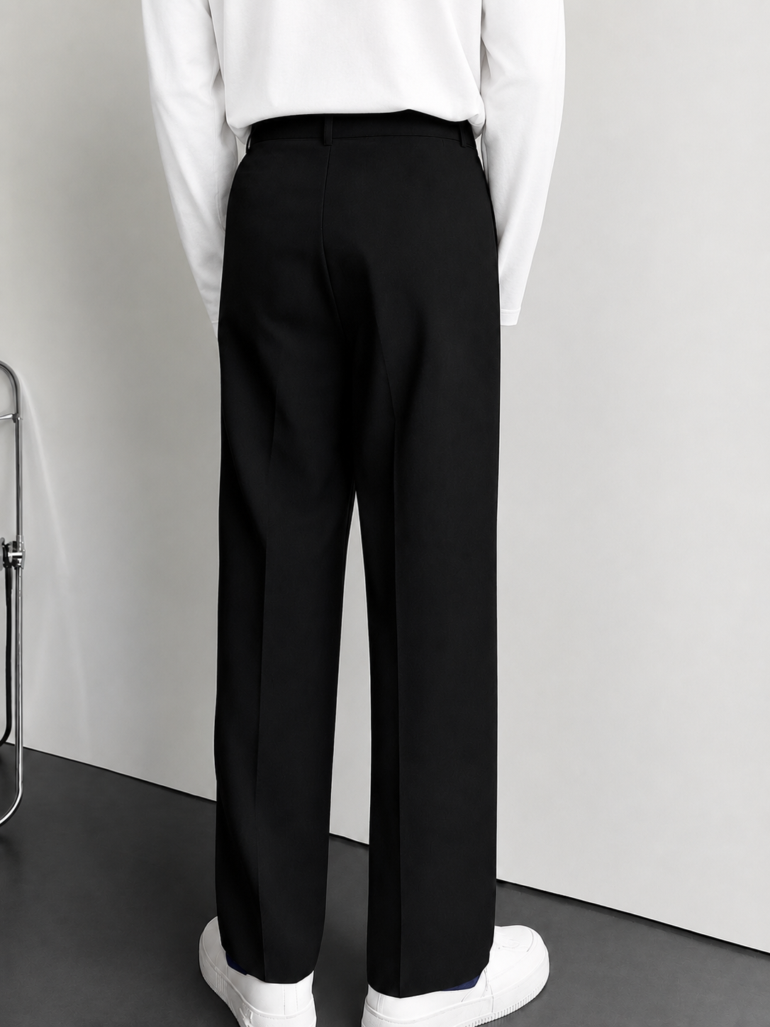Women's black high-waisted pleated wide-leg trousers with side pockets